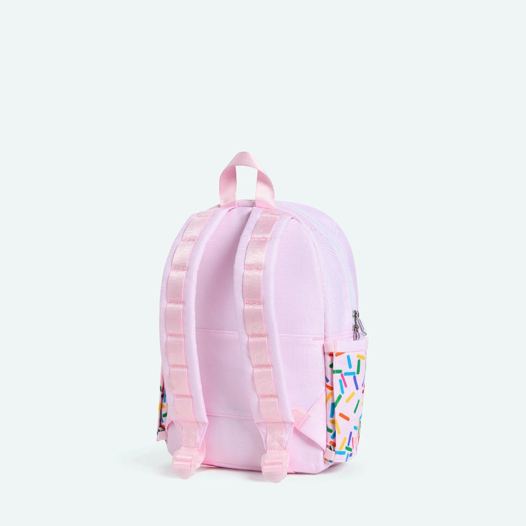 Pink backpack with colorful sprinkles pattern