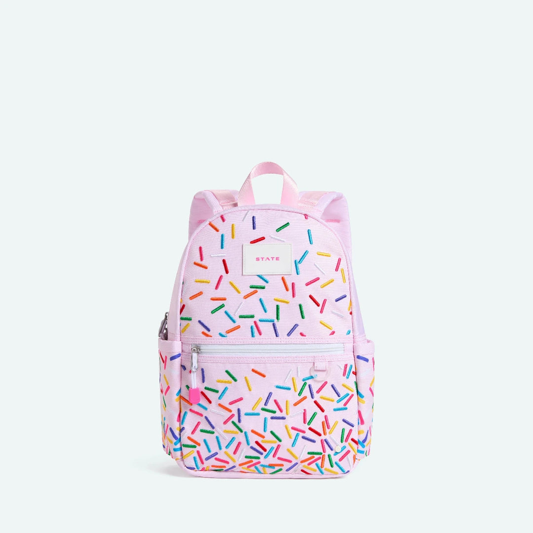 Pink backpack with colorful sprinkles pattern