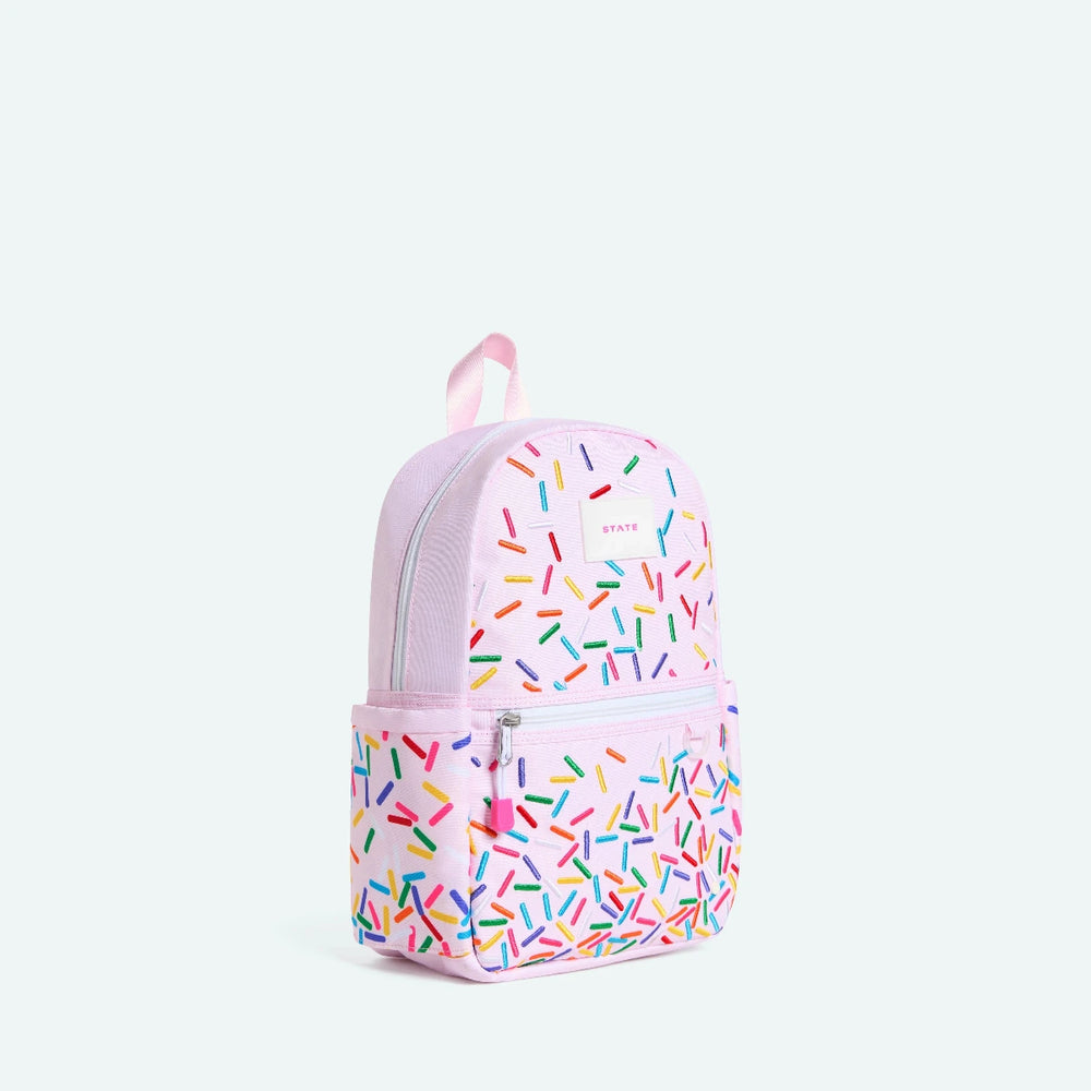 Pink backpack with colorful sprinkles pattern